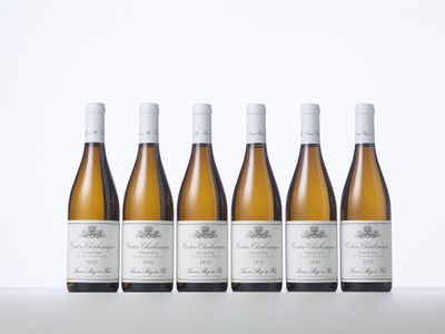 six bottles of white wine lined up in a row