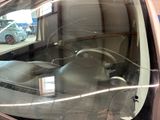 a reflection of a car in the window of a car