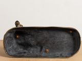 a close up of a black purse sitting on top of a wooden table