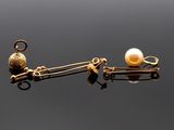 une photo d'une paire de boucles d'oreilles en or ornées de perles