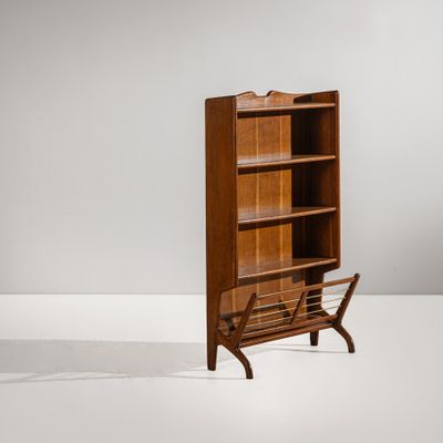 a wooden bookcase with a magazine rack on top of it