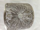 an image of a silver box sitting on top of a white cloth
