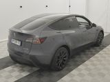 the back of a gray tesla model s parked in a garage