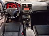 a dashboard of a car with a clock and a steering wheel
