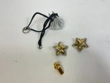 a pair of gold star charms and a black cord