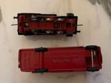 two toy trains sitting on a table next to each other