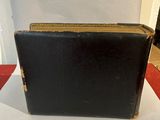 a black suitcase sitting on top of a red and white table