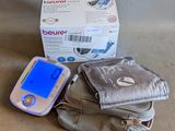 a cell phone sitting on top of a bag next to a box of tissues