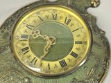 a clock with roman numerals on the face of it