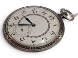 a silver pocket watch with roman numerals on the face