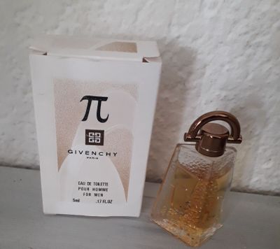 a bottle of perfume next to a box of perfume