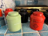 many different colored containers sitting on the kitchen counter