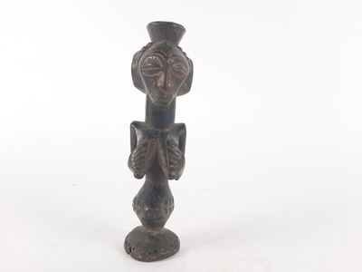 a small bronze statue of a bird on a pedestal