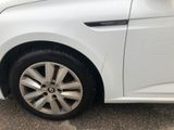 a close up of a white car parked in a parking lot