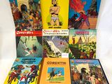 a lot of comic books sitting on a white surface