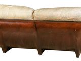 a brown and white couch with a wooden frame on it