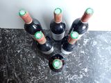 several bottles of wine are lined up on a counter top