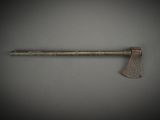 an old axe with a wooden handle on a gray background