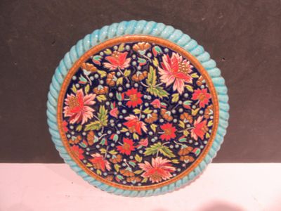 a blue plate with a floral design on it