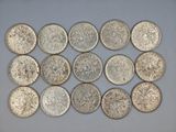 a bunch of silver coins sitting on top of a white surface