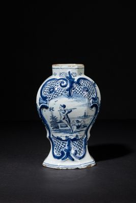 blue and white vase with a man on a boat in the water