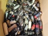 a cardboard box filled with assorted bottles of alcohol