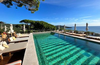 a large swimming pool in the middle of a patio area