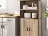 an image of a kitchen with a wooden cabinet and white dishes