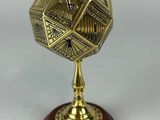 a brass plate with a wooden base and a wooden base