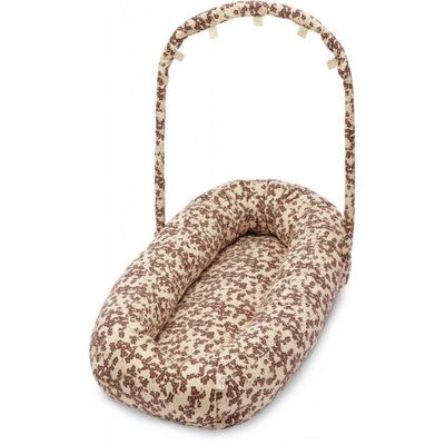 a brown and white dog bed in a basket on a white background
