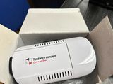 a white device in a box sitting on a table