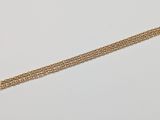 a close up of a gold chain bracelet on a white surface