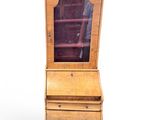 an image of a small wooden cabinet with a glass door