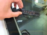 a person holding a ruler in front of a window