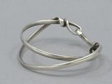 silver ring with a knot on the end of it
