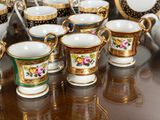 many cups and saucers sitting on a table
