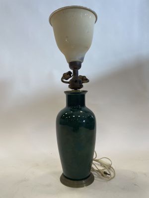 an image of a green vase with a lamp on it