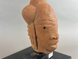 an image of a sculpture of a person ' s head on a stand