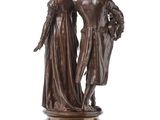 bronze statue of a man and a woman standing on a marble base