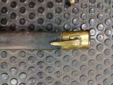 a close up of a knife on a metal surface