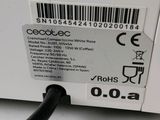 a label on the side of a microwave with a black cord