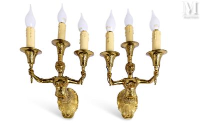 three brass candles are lit on a white background with a white background