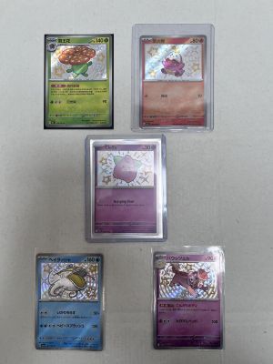 four different types of pokemon cards are displayed on a white surface