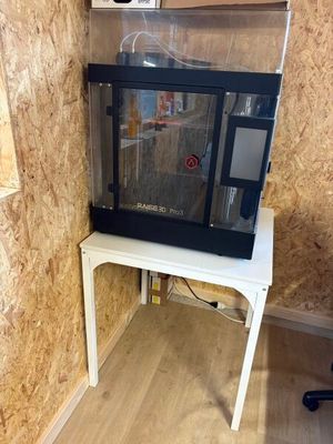 a fish tank sitting on a small table in the corner of a room
