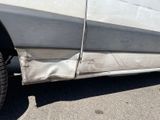a car that has been damaged and is sitting in the parking lot