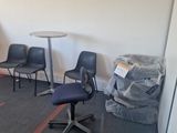 a room with chairs, a table, and a chair in it