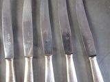 five knives that are sitting on a table
