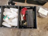 two containers with different items in them sitting on the floor