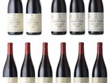 a group of bottles of red wine sitting next to each other