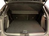 the back of a car with the trunk open and the seat folded down